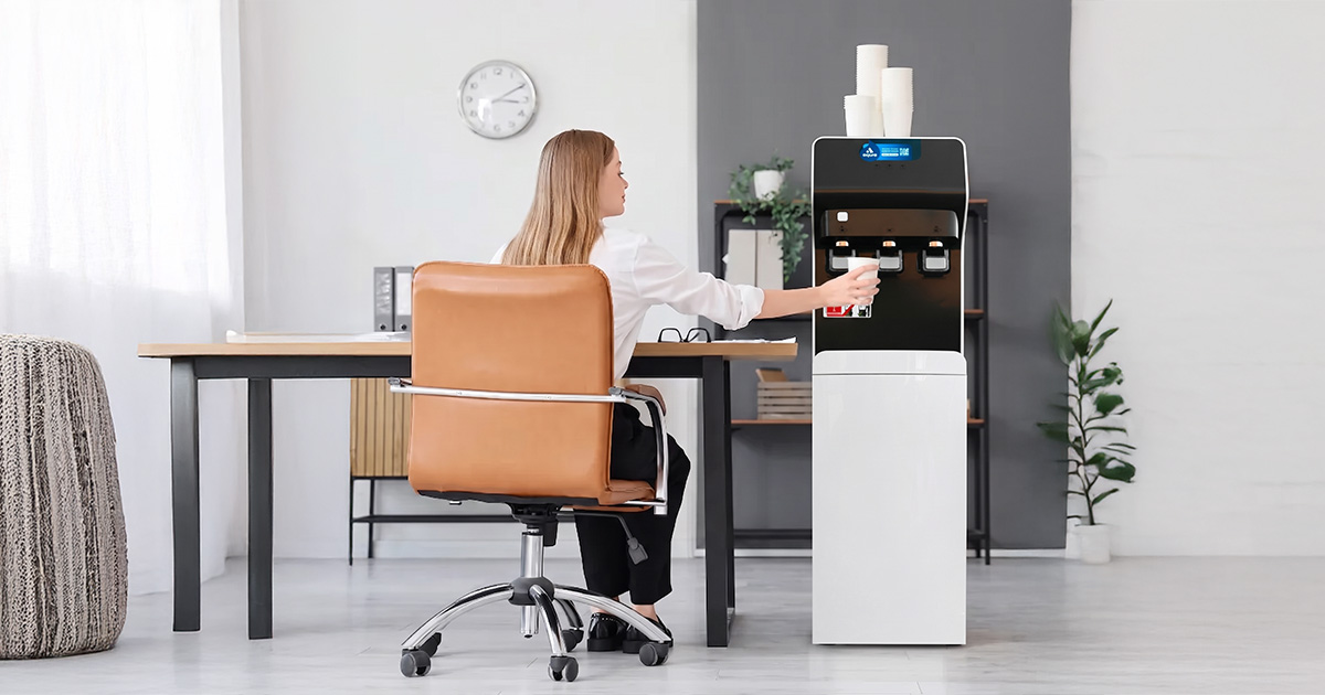Dispensador de agua filtrada en oficina moderna de Barcelona con empleados